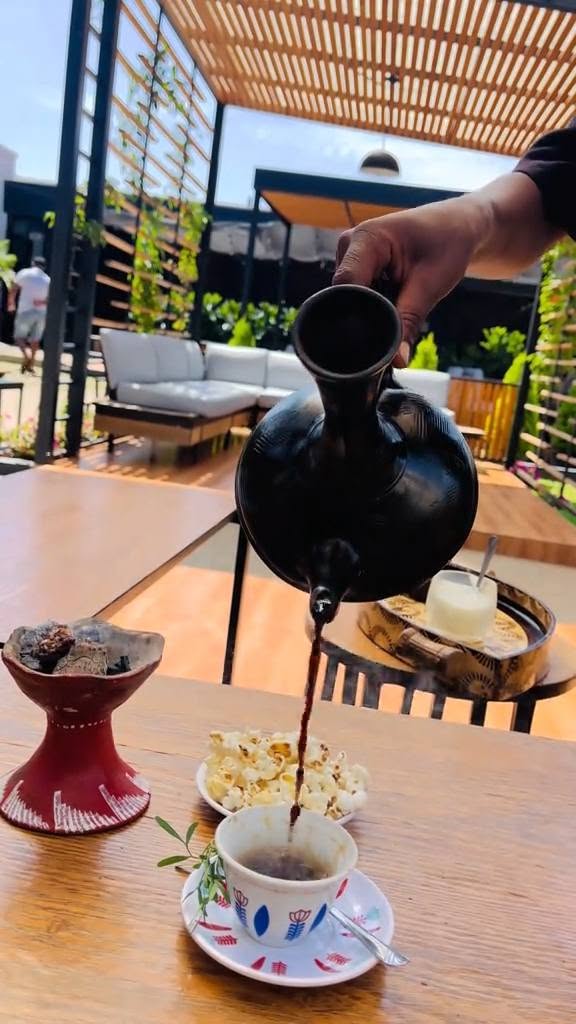Ethiopian jebena coffee pot pouring coffee